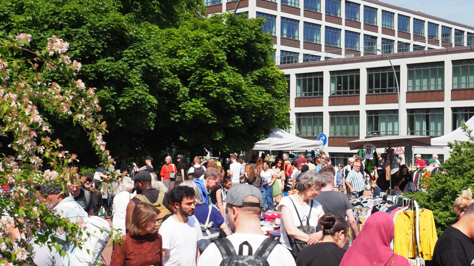 Menschenmenge auf einem Flohmarkt bei Sonnenschein