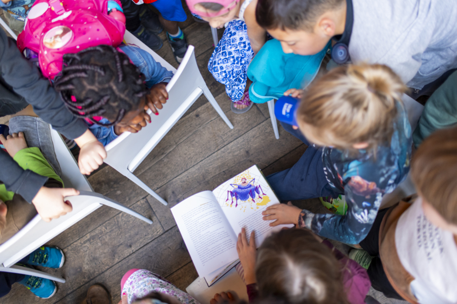 Kinder, die über ein Buch gebeugt sind