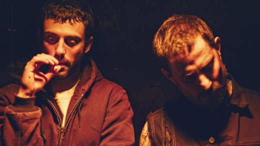Kosmo und Klaus aus dem Film "Rave on" in rotem Licht in einer Nacht-Szene