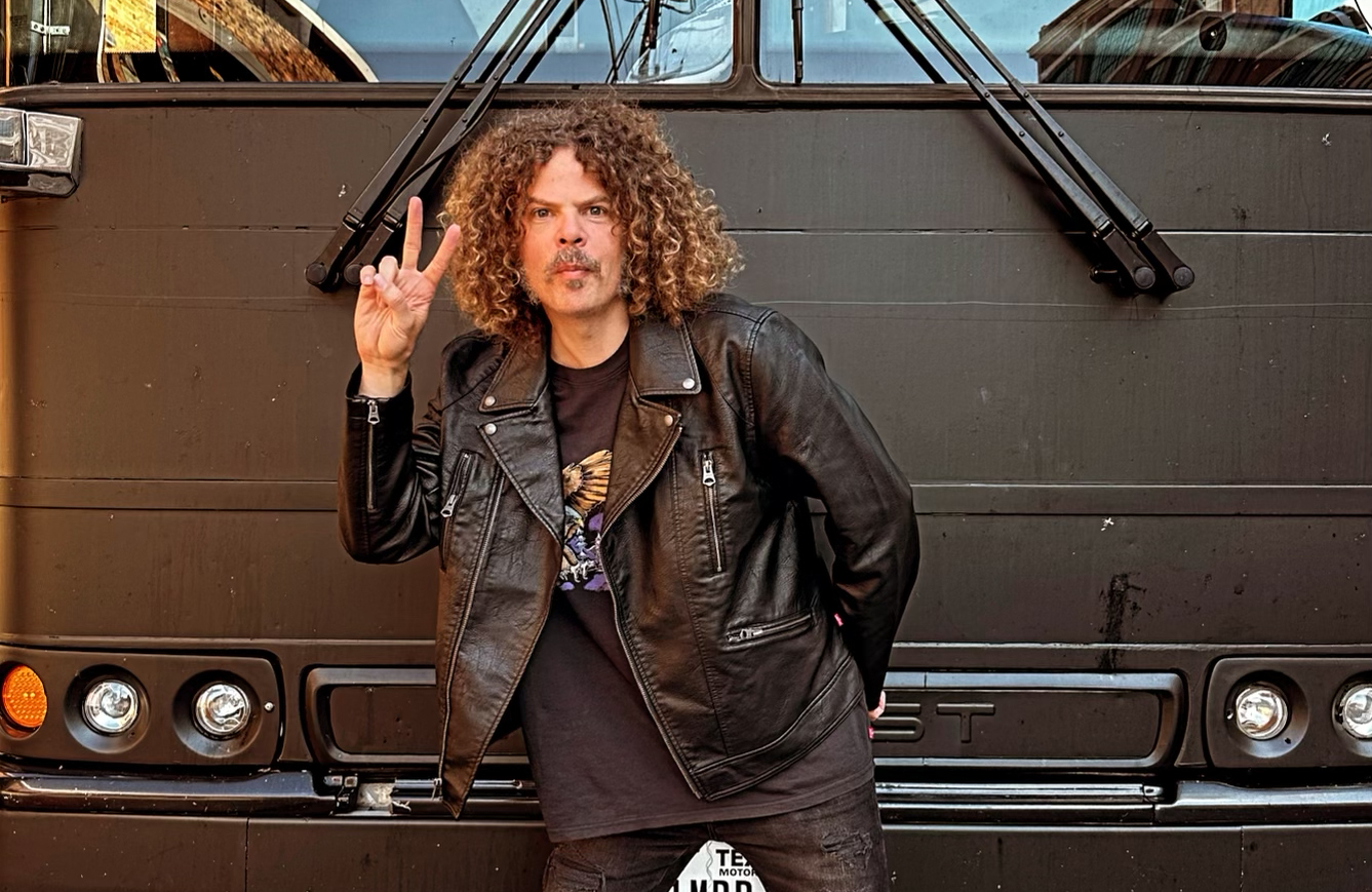 Bild vom Front-Sänger von Wolfmother vor einem Bus