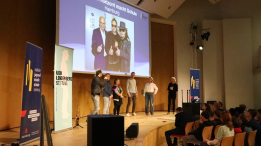 Auf der Bühne: Die Künstlerische Leitung des Originalmusicals und des Projektes Noah Fischer (links) und Elisabeth Engstler (rechts) mit Vertretern der beiden Gewinner-Schulen (Mitte), der ATW Hamburg und des Gymnasium Farmsen